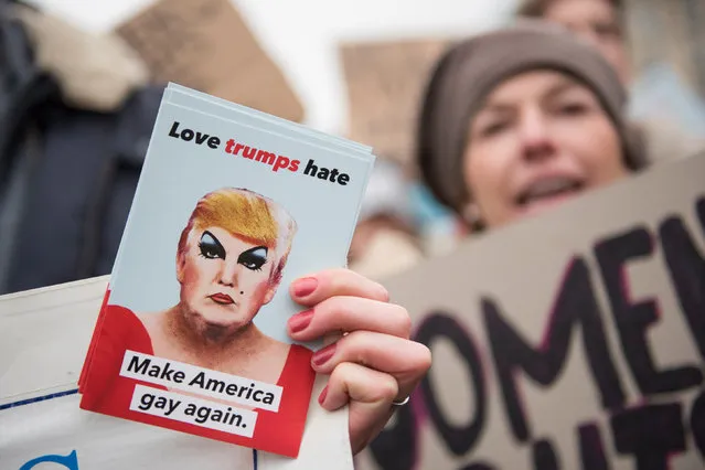 Women attend a protest for women's rights and freedom in solidarity with the Women's March on Washington with a sign that reads “Love trumpf hate – make America gay again” in front of Brandenburger Tor on January 21, 2017 in Berlin, Germany. The Women's March originated in Washington DC but soon spread to be a global march calling on all concerned citizens to stand up for equality, diversity and inclusion and for Women's rights to be recognised around the world as human rights. Global marches are now being held, on the same day, across seven continents. (Photo by Steffi Loos/Getty Images)