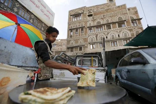 A food vendor works in his roadside stall as he waits for customers in Yemen's capital Sanaa March 3, 2016. (Photo by Khaled Abdullah/Reuters)