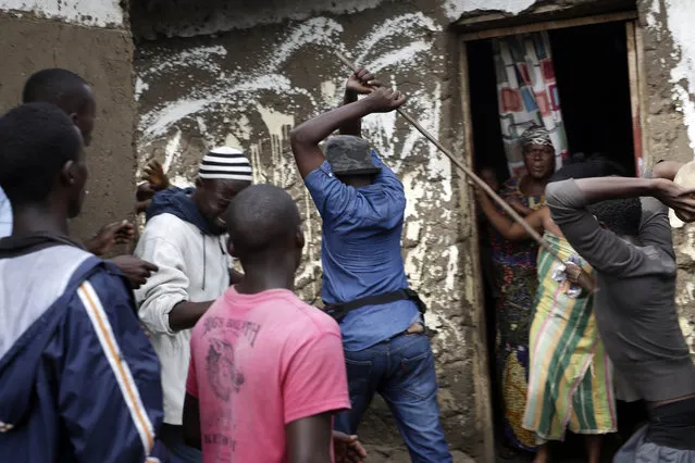 Demonstrators corner a suspected member of the ruling party's Imbonerakure youth militia at his home in the Cibitoke district of Bujumbura, Burundi, Thursday May 7, 2015. (Photo by Jerome Delay/AP Photo)