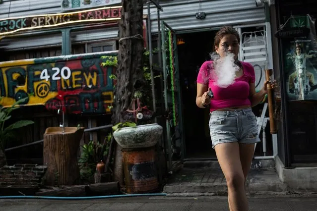 Doughnut smokes cannabis with a bong, outside a cannabis club called the Green Party in the outskirts of Bangkok,  Thailand, on October 7, 2023. (Photo by Jorge Silva/Reuters)