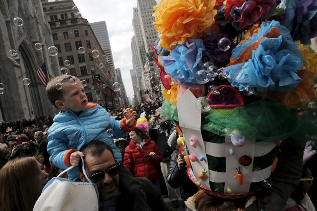 People take part in the annual Easter Parade and Bonnet Festival along 5th Avenue in New York City March 27, 2016. (Photo by Brendan McDermid/Reuters)