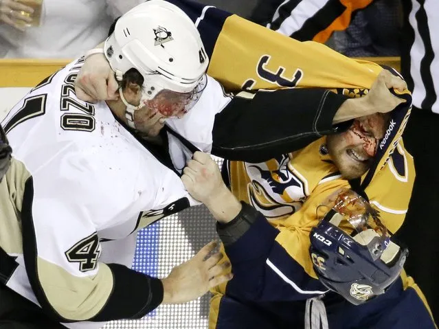 Pittsburgh Penguins defenseman Robert Bortuzzo (41) fights with Nashville Predators forward Colin Wilson (33) in the first period of an NHL hockey game Tuesday, March 4, 2014, in Nashville, Tenn. (Photo by Mark Humphrey/AP Photo)