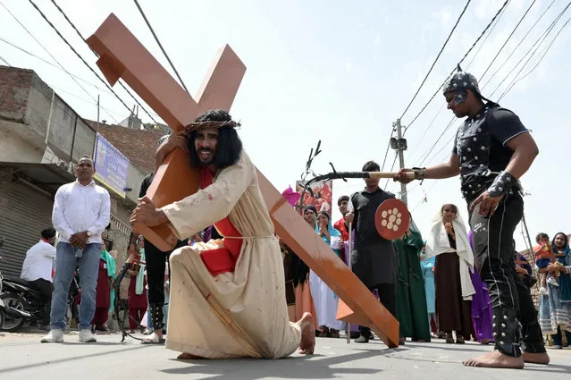 Christians devotees re-enact the crucifixion of Jesus Christ during a Good Friday procession in Amritsar on March 29, 2024. (Photo by Narinder Nanu/AFP Photo)