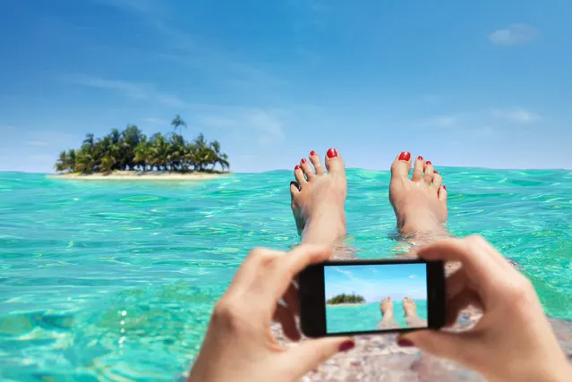 Woman is taking a picture on vacation with the smartphone. (Photo by TeamDAF/Getty Images)