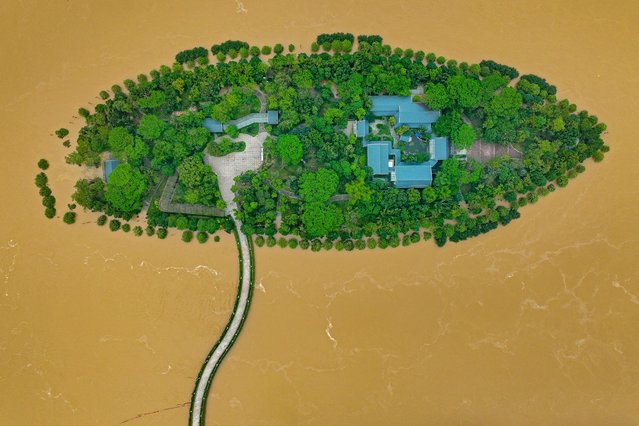 This aerial photograph taken on April 22, 2024 shows a flooded island after heavy rains in Qingyuan, in southern China's Guangdong province. More than 100,000 people have been evacuated due to heavy rain and fatal floods in southern China, with the government issuing its highest-level rainstorm warning for the affected area on April 23. (Photo by AFP Photo/China Stringer Network)