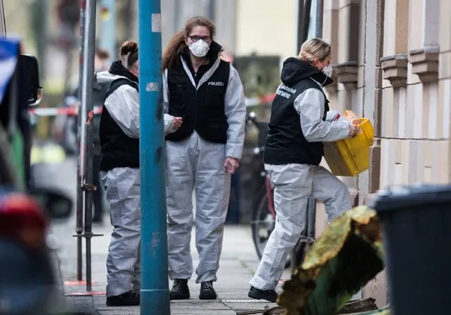 Forensic experts of the police secure evidences on March 10, 2017 from a house at Sedanstrasse street in Herne, western Germany, close to the place where a 19-year-old man suspected of stabbing a nine-year-old boy to death was arrested the night before. After his arrest, the suspected young man put the investigators on the trail of an apartment at Sedanstrasse he had just burned and in which the dead body of a man was found. (Photo by Marcel Kusch/AFP Photo/DPA)