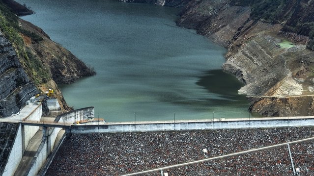 A view of the Mazar dam and low water levels in the Mazar reservoir, in the province of Azuay, Ecuador, 18 April 2024. Ecuador faces blackouts of up to eight hours this 18 April and 19 April, due to low water levels in hydroelectric reservoirs, a serious energy crisis that has forced the Government to suspend the working day and school classes, amid complaints of alleged sabotage before the referendum on 21 April called for by the president Daniel Noboa, on reforms in security, justice and employment. (Photo by Robert Puglla/EPA)