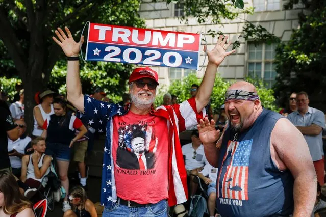 Supporters of US President Donald J. Trump join others to watch 'America's Independence Day Parade' along Constitution Avenue during US Independence Day celebrations in Washington, DC, USA, 04 July 2019. The “Salute to America” Fourth of July activities include remarks by US President Donald J. Trump, a parade, military flyovers and fireworks. (Photo by Erik S. Lesser/EPA/EFE)