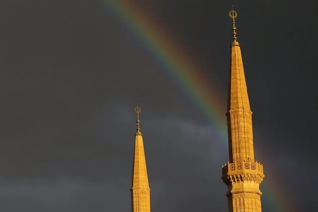 A rainbow is seen above the minarets of al-Amin mosque in downtown Beirut, December 2, 2015. (Photo by Jamal Saidi/Reuters)