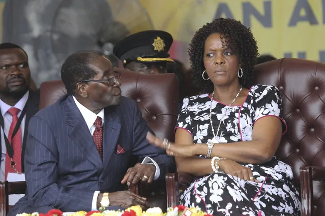 Zimbabwean President Robert Mugabe and his wife Grace are seen during his birthday celebrations in Masvingo in this Saturday, February 27, 2016 file photo. Zimbabwean President Robert Mugabe plucked her from the secretarial pool decades ago to become his wife, and now Grace Mugabe is stirring speculation that she wants to succeed her 93-year-old husband as leader.The 51-year-old Grace Mugabe is now her elderly husband's No. 1 protector, helping him when he struggled with a shovel at a recent tree-planting ceremony and declaring that he should run “as a corpse” in next year's election if he dies before the vote. 
(Photo by Tsvangirayi Mukwazhi/AP Photo)