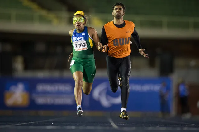 Terezinha Guilhermina and guide Guilherme Santana of Brazil compete in the Women's 200m T11 final during day one of the Open Caixa Loterias 2014 Paralympics Athletics competition at Ibirapuera Sports Complex on April 24, 2014 in Sao Paulo, Brazil. (Photo by Jonne Roriz /Getty Images)