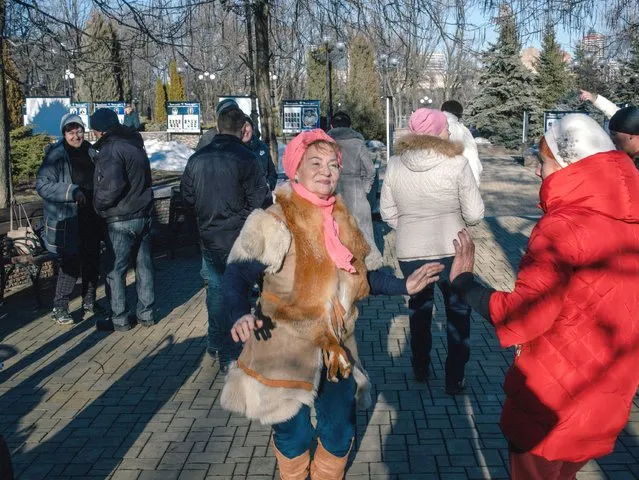 Sina, 75, dancing at the park in Donetsk on February 13, 2022 say “There is war and we are dancing. How else? Otherwise you can not endure it. I'm from Russia but we lived better in Ukraine. My pension is 11.000 rubles. Can I live from this? No. That's why I continue working as a teacher”. (Photo by The Washington Post)