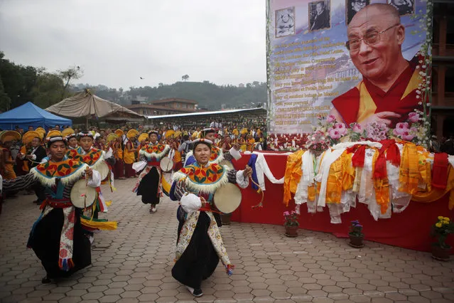 Tibetans dance as they celebrate the 80th birthday of their spiritual leader, the Dalai Lama, in Kathmandu, Nepal, Monday, July 6, 2015. (Photo by Niranjan Shrestha/AP Photo)