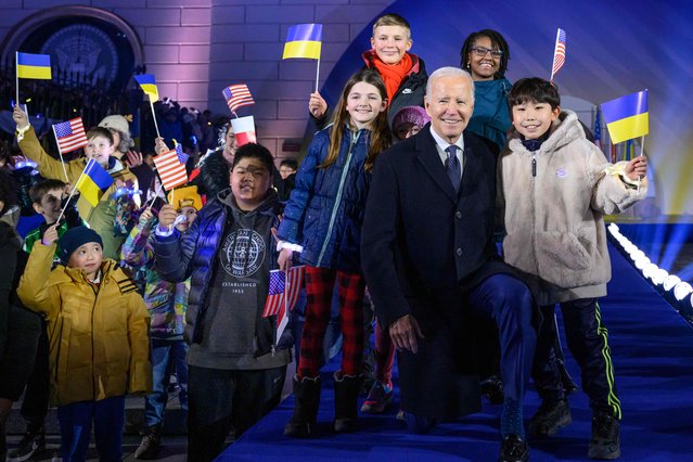US President Joe Biden stands amid children cheering with US, Polish and Ukrainian flags after he delivered a speech in front of the Royal Warsaw Castle Gardens in Warsaw, Poland on February 21, 2023. US President Joe Biden said support for wartorn Ukraine “will not waver” as he delivered a speech in Poland ahead of the first anniversary of Russia's invasion. (Photo by Mandel Ngan/AFP Photo)