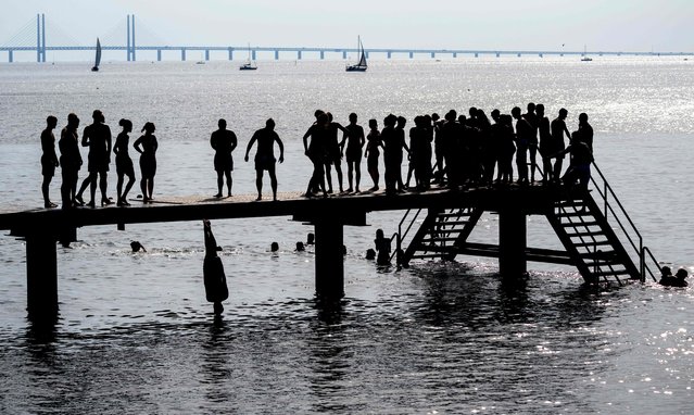 People enjoy a swim on a hot summer day in Vastra Hamnen in Malmo, southern Sweden, on June 27, 2024. A heat wave brought the hottest temperatures so far this year and air temperatures crossed the 30-degree Celcius mark on June 27. (Photo by Johan Nilsson/TT News Agency via AFP Photo)