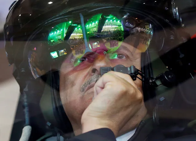 Turkish Prime Minister Binali Yildirim looks out from a T-129 ATAK attack helicopter at IDEF'17, the 13th International Defence Industry Fair, in Istanbul, Turkey, May 9, 2017. (Photo by Murad Sezer/Reuters)