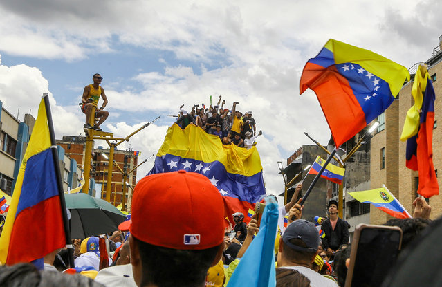 Supporters of Venezuelan opposition leader Maria Corina Machado and Venezuelan presidential candidate Edmundo Gonzalez attend a campaign rally in Valencia, Carabobo state, Venezuela on July 13, 2024. (Photo by Juan Carlos Hernández/AFP Photo)