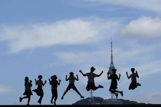 Middle school students jump in the air for a photograph at the National Museum of Korea in Seoul, South Korea, Wednesday, July 10, 2024. (Photo by Ahn Young-joon/AP Photo)