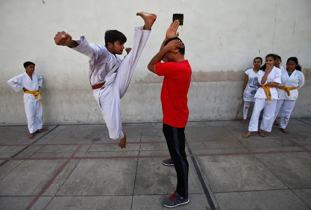 A student practices martial arts inside a school in Ahmedabad, India, May 19, 2017. (Photo by Amit Dave/Reuters)