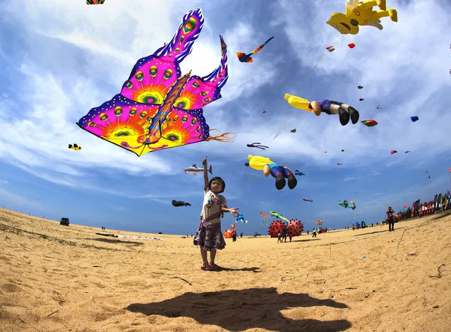 “Flying A Kite”. This image of a little girl flying a kite was shot during The International Kite Festival in Pantai Getting, Kelantan. This event is held yearly in May, and showcases the many different kites by other countries. Photo location: Pantai Geting, Kelantan, Malaysia. (Photo and caption by Ng Yeow Kee/National Geographic Photo Contest)