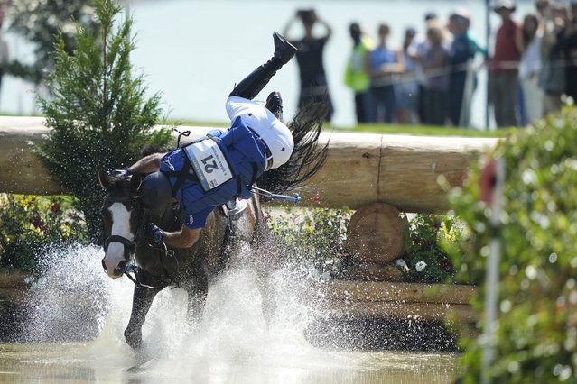 Ecuador's Ronald Zabala G., riding, Forever Young Wundermaske, fall off their horse during the Equestrian Cross Country competition at Chateau de Versailles for the 2024 Summer Olympics, Sunday, July 28, 2024, in Versailles, France. (Photo by Mosa'ab Elshamy/AP Photo)