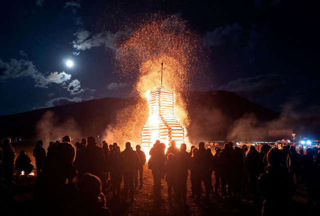 People gather to celebrate annual traditional Bonfire on Holy Saturday, after a 2-years break caused by COVID-19 restrictions, at Mauterndorf, Austria on April 16, 2022. (Photo by Kacper Pempel/Reuters)