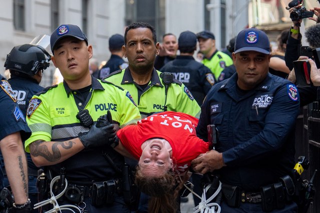 Police officers detain a pro-Palestinian protestor at the New York Stock Exchange (NYSE) during a protest on the ongoing war between Israel and Hamas in New York City, U.S., October 14, 2024. (Photo by David Dee Delgado/Reuters)