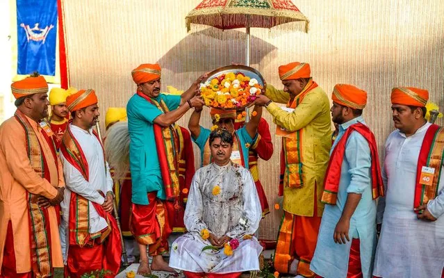 In this photo taken on January 29, 2020, “Thakore Saheb” (princely title) Mandhatasinh Jadeja (C), Rajkot's 17th King, participates in a coronation ceremony as part of Hindu religious rituals, in Rajkot some 220 kms from Ahmedabad. (Photo by Sam Panthaky/AFP Photo)