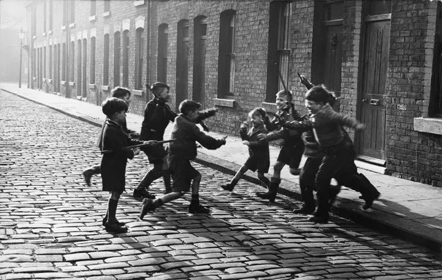 Children Playing Cowboys and Indians in Salford, UK, 1957. (Photo by Neil Libbert/The Guardian)