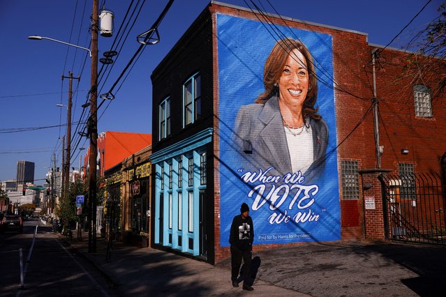 A man walks past a mural in support of Democratic presidential nominee and U.S. Vice President Kamala Harris in Atlanta, Georgia on October 23, 2024. (Photo by Hannah McKay/Reuters)