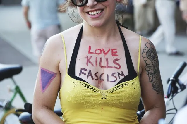 A protester with a slogan painted on her body stands outside the perimeter of the Republican National Convention in Cleveland, Ohio, U.S. July 18, 2016. (Photo by Aaron Josefczyk/Reuters)