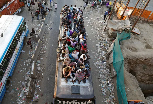 Migrant workers travel on a crowded bus as they return to their villages, during a 21-day nationwide lockdown to limit the spreading of coronavirus disease (COVID-19), in Ghaziabad, on the outskirts of New Delhi, India, March 29, 2020. (Photo by Adnan Abidi/Reuters)