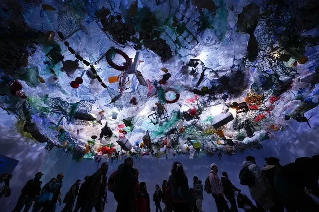 People walk in an exhibit simulating sea pollution during the 11th edition of Technopolis science, technology, industry and art exhibit in Buenos Aires, Argentina, Sunday, July 17, 2022. (Photo by Natacha Pisarenko/AP Photo)