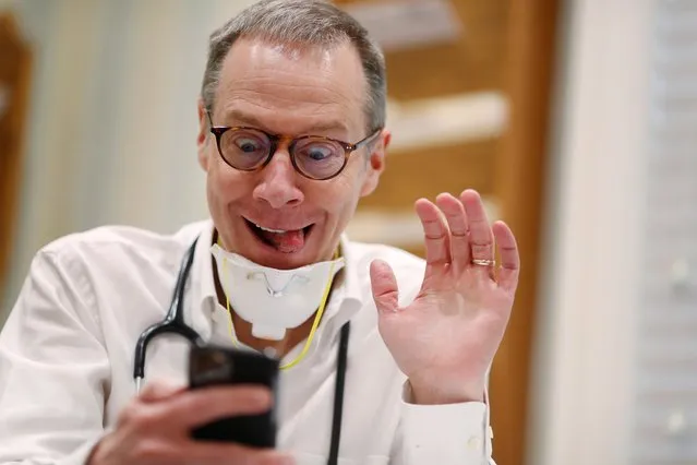 Dr Greg Gulbransen takes part in a telemedicine call with a patient while maintaining visits with both his regular patients and those confirmed to have the coronavirus disease (COVID-19) at his pediatric practice in Oyster Bay, New York, U.S., April 13, 2020. (Photo by Lucas Jackson/Reuters)