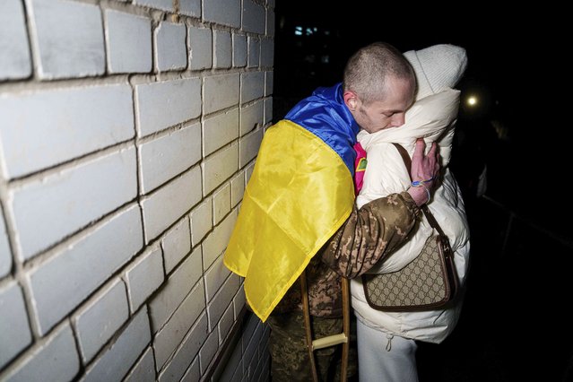 Ukrainian serviceman Yevhen Liashenko, hugs his wife Kateryna after returning from captivity during a POWs exchange between Russia and Ukraine, in Ukraine, Monday December 30, 2024. (Photo by Evgeniy Maloletka/AP Photo)