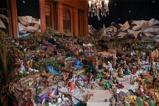 General view of a large nativity scene created 79 years ago in a main room of a house, the figures number more than 400 and were mostly donated by neighbors over the years, in Buenos Aires, Argentina, on December 30, 2023. In the heart of the San Telmo neighborhood in Buenos Aires, there is a beautiful and enormous Christmas manger scene and for which two sisters of Italian descent born in Argentina maintain a long tradition of commitment and devotion. Teresa and Susana Gargiulo are responsible for maintaining the legacy started by their mother 79 years ago, when she began putting together a humble manger with plaster figures in the main room of her house in the heritage San Telmo neighborhood, and which today has reached 24 meters. squares and more than 440 pieces that form a complete landscape inspired by Bethlehem, and the customs of the era of Jesus. The work is open to the public from the window of the house from December 8 to January 6 when the Three Wise Men arrive at the manger. (Photo by Luciano Gonzalez/Anadolu via Getty Images)