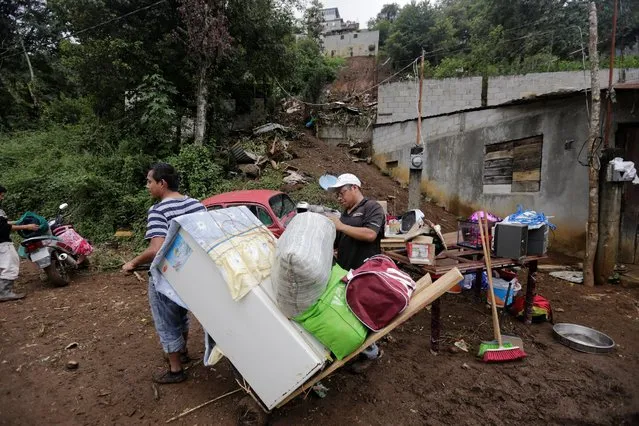 Residents recover belongings from their house, which was damaged by a mudslide, in the aftermath of Tropical Storm Earl in the town of Huauchinango, in Puebla state, Mexico, August 8, 2016. (Photo by Imelda Medina/Reuters)