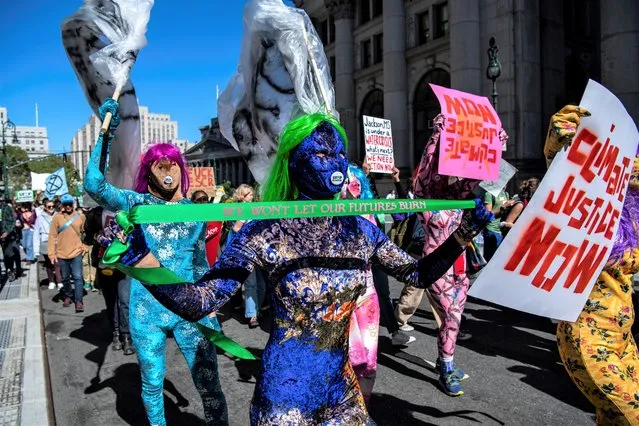 Activists gather and walk through lower Manhattan for the Global Climate Strike protests, Friday, September 23, 2022, in New York. (Photo by Brittainy Newman/AP Photo)