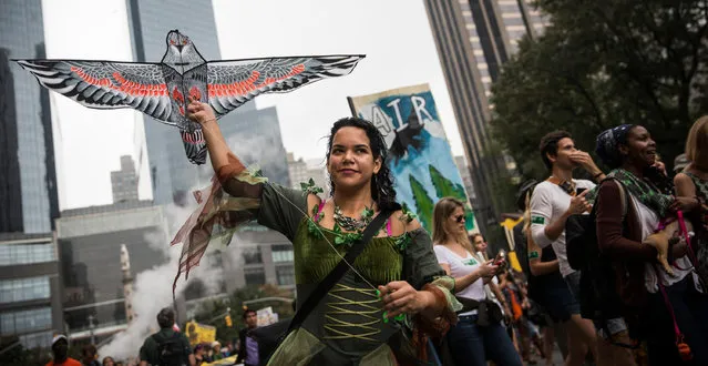 People protest for greater action against climate change during the People's Climate March on September 21, 2014 in New York City. (Photo by Andrew Burton/Getty Images)