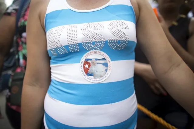A woman wears a sticker advertising the visit of Pope Francis to Cuba during the annual procession of Our Lady of Charity, the patron saint of Cuba, on the streets of downtown Havana, September 8, 2015. (Photo by Alexandre Meneghini/Reuters)