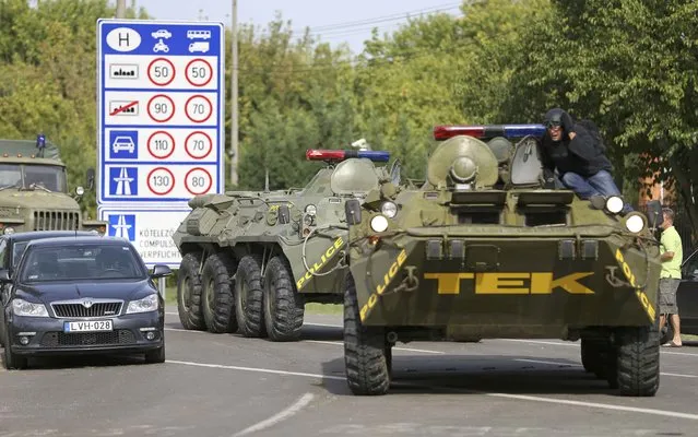 Hungarian armoured personnel carriers are deployed at the border crossing with Serbia in Roszke, Hungary September 16, 2015. (Photo by Dado Ruvic/Reuters)