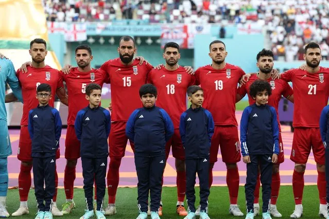 Iran players listen to the national anthem ahead of the Qatar 2022 World Cup Group B football match between England and Iran at the Khalifa International Stadium in Doha on November 21, 2022. (Photo by Fadel Senna/AFP Photo)