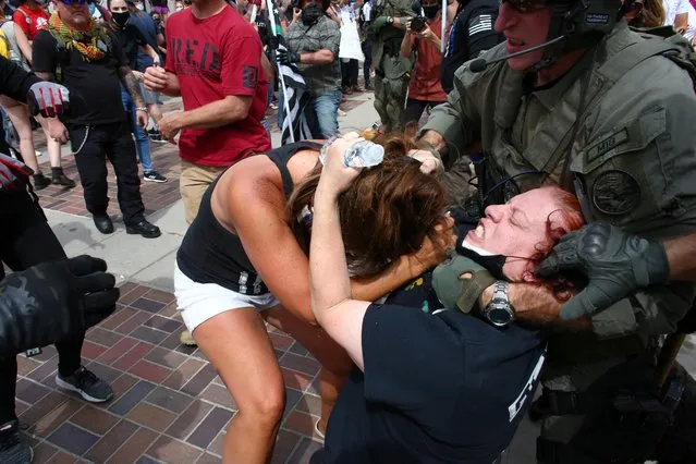 Police intervene as two women fight at a pro-law enforcement rally that clashed with counter protesters demonstrating against racial inequality, in Denver, Colorado, U.S. July 19, 2020. (Photo by Kevin Mohatt/Reuters)