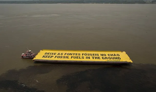 Greenpeace activists use a boat to protest against what they say is the exploitation of oil and gas in indigenous lands and Amazon forest, at the confluence point between the Rio Negro and the Rio Solimoes in Manaus, Amazonas state, Brazil, October 1, 2015. (Photo by Bruno Kelly/Reuters)