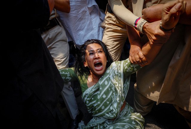 Police detain Shama Mohamed, a member of India's main opposition Congress party as she and others protest outside the party headquarters after the party's senior leader, Rahul Gandhi, and his mother Sonia Gandhi were accused in a money laundering case by the country’s financial crime agency, in New Delhi, India on April 16, 2025. (Photo by Adnan Abidi/Reuters)