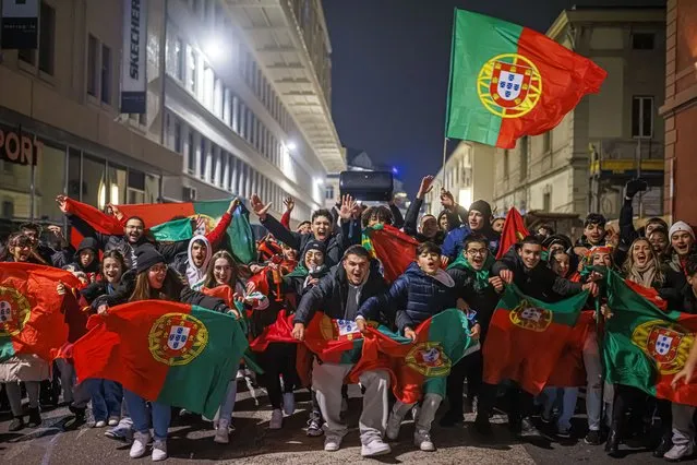 Portuguese fans celebrate after the World Cup Qatar 2022 round of 16 soccer match between Portugal and Switzerland in the streets of Lausanne, Switzerland, Tuesday, December 6, 2022. (Photo by Valentin Flauraud/Keystone via AP Photo)