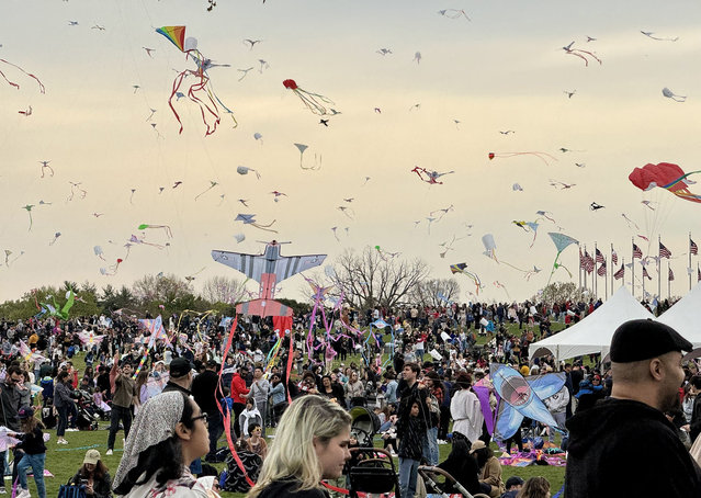 Kite flyers and fans take part in the Blossom Kite Festival on the National Mall in Washington, DC, on March 30, 2024. The event is part of the annual National Cherry Blossom Festival. (Photo by Daniel Slim/AFP Photo)