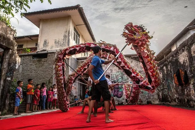A dragon dance troupe practice their moves in Bogor on January 9, 2023, ahead  of the Lunar New Year celebrations on January 22. (Photo by Aditya Aji/AFP Photo)