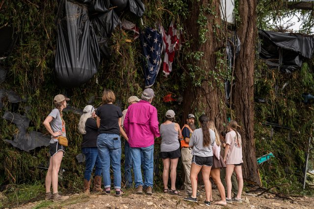 Residents and Mike Wong, Animal Control Officer with Kerr County Environmental Health & Animal Services, work to recover the remains of a dog from a cypress tree in Louise Hays Park as water levels recede on July 5, 2025 in Kerrville, Texas. Heavy rainfall caused flooding along the Guadalupe River in central Texas with multiple fatalities reported. (Photo by Eric Vryn/Getty Images)