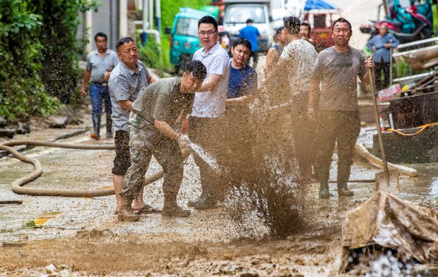 Residents clean up mud after a flood in Congjiang county, Qiandongnan Miao and Dong Autonomous Prefecture, Guizhou province, China on June 25, 2025. (Photo by cnsphoto via Reuters)